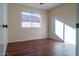 Simple bedroom with hardwood floors and a window at 5730 E Holmes Ave, Mesa, AZ 85206