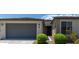 Single-story home with gray exterior, two-car garage, and landscaping at 19031 W Palo Verde Dr, Litchfield Park, AZ 85340