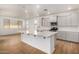 Modern kitchen with gray cabinets, island, and stainless steel appliances at 19031 W Palo Verde Dr, Litchfield Park, AZ 85340