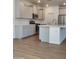 Spacious kitchen with stainless steel appliances, an island, and light-colored cabinets at 19031 W Palo Verde Dr, Litchfield Park, AZ 85340