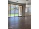 Bright open-plan living room with tile floors and sliding door access to the backyard at 19031 W Palo Verde Dr, Litchfield Park, AZ 85340