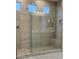 Modern tiled walk-in shower with glass door at 19031 W Palo Verde Dr, Litchfield Park, AZ 85340
