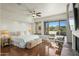 Main bedroom with fireplace, hardwood floors, and golf course views at 40167 N 110Th Pl, Scottsdale, AZ 85262