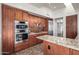 Modern kitchen with wood cabinets and granite countertops at 40167 N 110Th Pl, Scottsdale, AZ 85262