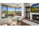 Relaxing living room with fireplace and scenic golf course view at 40167 N 110Th Pl, Scottsdale, AZ 85262