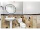 Small bathroom with pedestal sink, toilet and stone tile at 3799 S Skyline Dr, Gilbert, AZ 85297