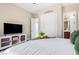 Bedroom with king-size bed, TV, and access to bathroom at 3799 S Skyline Dr, Gilbert, AZ 85297