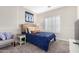 Cozy bedroom with navy blue bedding and window shutters at 3799 S Skyline Dr, Gilbert, AZ 85297