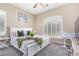 Bright bedroom with a king-size bed, plant, and large window with shutters at 3799 S Skyline Dr, Gilbert, AZ 85297
