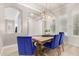 Dining room with wooden table, blue velvet chairs, and chandelier at 3799 S Skyline Dr, Gilbert, AZ 85297