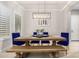 Dining room with wooden table, blue velvet chairs, and chandelier at 3799 S Skyline Dr, Gilbert, AZ 85297