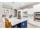Modern kitchen with white cabinets, blue island, and stainless steel appliances at 3799 S Skyline Dr, Gilbert, AZ 85297