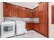 Laundry room with wood cabinets, washer and dryer at 3799 S Skyline Dr, Gilbert, AZ 85297