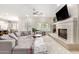 Spacious living room with sectional sofa, fireplace, and large windows at 3799 S Skyline Dr, Gilbert, AZ 85297