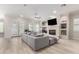 Open living area with sectional sofa, fireplace, and wood floors at 3799 S Skyline Dr, Gilbert, AZ 85297