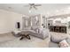 Open living room with grey sectional sofa and large windows at 3799 S Skyline Dr, Gilbert, AZ 85297