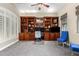 Home office with built-in wooden shelving and two blue chairs at 3799 S Skyline Dr, Gilbert, AZ 85297
