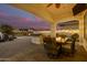 Covered patio with outdoor fireplace and dining area at 3799 S Skyline Dr, Gilbert, AZ 85297