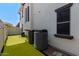 Landscaped side yard with AC units and putting green at 3799 S Skyline Dr, Gilbert, AZ 85297