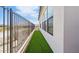 Side yard with artificial turf adds a touch of greenery for a pet-friendly and low-maintenance backyard experience at 4353 N 203Rd Ave, Buckeye, AZ 85396