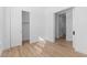 Neutral bedroom featuring wood-look flooring, closet, and adjacent entryways at 4353 N 203Rd Ave, Buckeye, AZ 85396