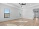 Bright bedroom with tray ceiling, natural light, and barn door to bath at 4353 N 203Rd Ave, Buckeye, AZ 85396