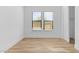 Well-lit bedroom with wood-look flooring and closet, with a neutral color palette at 4353 N 203Rd Ave, Buckeye, AZ 85396