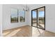 Dining area with modern chandelier, sliding glass door access to patio, and many large windows at 4353 N 203Rd Ave, Buckeye, AZ 85396