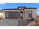 Charming single-Gathering home showcases a modern design and appealing curb appeal with a gray brick driveway at 4353 N 203Rd Ave, Buckeye, AZ 85396