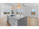 Open kitchen and dining area featuring a large island, pendant lighting, and plenty of natural light at 4353 N 203Rd Ave, Buckeye, AZ 85396