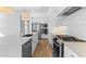 Modern kitchen featuring white cabinets, stainless steel appliances, and a spacious island with a sink at 4353 N 203Rd Ave, Buckeye, AZ 85396