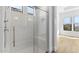 Luxurious shower with glass door, tiled walls, and ample natural light at 4353 N 203Rd Ave, Buckeye, AZ 85396