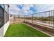 Backyard with artificial turf, gravel accents, and metal fencing at 4359 N 203Rd Ave, Buckeye, AZ 85396