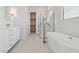 Elegant bathroom with a soaking tub, glass shower, and double vanity at 4359 N 203Rd Ave, Buckeye, AZ 85396