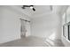 Bedroom with decorative wall, tray ceiling, and sliding door to bathroom at 4359 N 203Rd Ave, Buckeye, AZ 85396