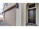 A close-up view of the front door and two-car garage at 4359 N 203Rd Ave, Buckeye, AZ 85396