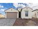 Stunning home featuring a neutral palette, an attached two-car garage, and an easy to maintain xeriscaped front yard at 4359 N 203Rd Ave, Buckeye, AZ 85396