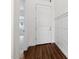 Hallway with wood-look tile flooring and white wainscoting at 4359 N 203Rd Ave, Buckeye, AZ 85396