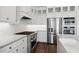 This kitchen features beautiful white cabinetry, stainless steel appliances, and a large stove and oven at 4359 N 203Rd Ave, Buckeye, AZ 85396