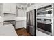 This kitchen features beautiful white cabinetry, stainless steel appliances, and double wall ovens at 4359 N 203Rd Ave, Buckeye, AZ 85396