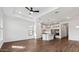 Open living space with wood-look tile, tray ceiling, and direct access to a modern kitchen at 4359 N 203Rd Ave, Buckeye, AZ 85396