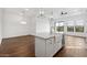 The open-concept floor plan flows into the kitchen with views of the large quartz kitchen island at 4359 N 203Rd Ave, Buckeye, AZ 85396