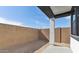 Fenced backyard with dirt and a covered patio, offering privacy and outdoor potential at 20311 W Montecito Ave, Buckeye, AZ 85396