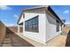 A new home construction backyard features sleek, modern white stucco and an open patio at 20311 W Montecito Ave, Buckeye, AZ 85396