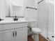 Modern bathroom featuring a white vanity, toilet, and a glass-enclosed tiled shower at 20311 W Montecito Ave, Buckeye, AZ 85396