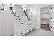 A luxurious bathroom boasts double sinks, sleek fixtures, and a walk-in closet at 20311 W Montecito Ave, Buckeye, AZ 85396
