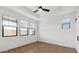 Bright bedroom with wood-look tile floors, crisp white walls, and well-lit by ample windows at 20311 W Montecito Ave, Buckeye, AZ 85396