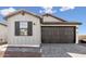 Charming home featuring a two-car garage and gray brick driveway at 20311 W Montecito Ave, Buckeye, AZ 85396