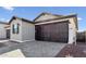Charming home featuring a two-car garage and gray brick driveway at 20311 W Montecito Ave, Buckeye, AZ 85396