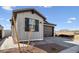 Charming home featuring a two-car garage and gray brick driveway at 20311 W Montecito Ave, Buckeye, AZ 85396